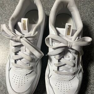 Puma women’s white leather sneakers.
